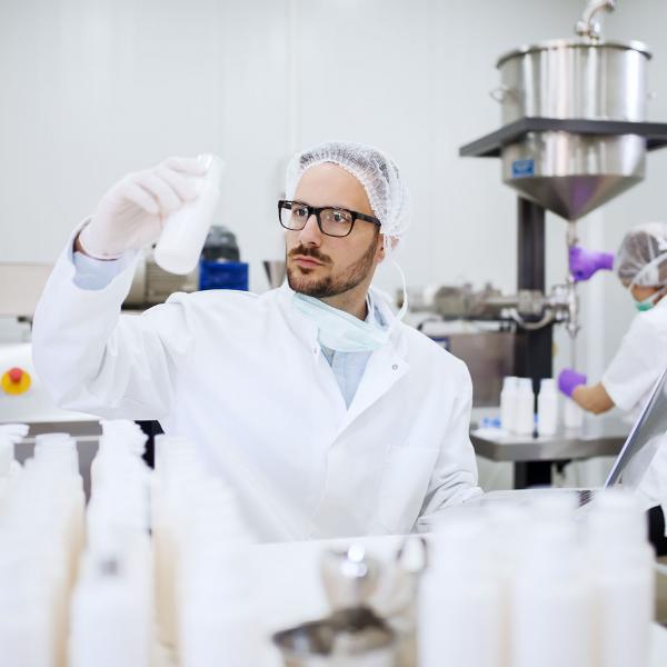 Scientist looking at a bottle in an advanced manifesting infant nutrition facility