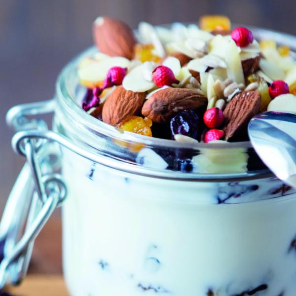 Static image of a bowl of yoghurt with nuts and berries decorating the top. 