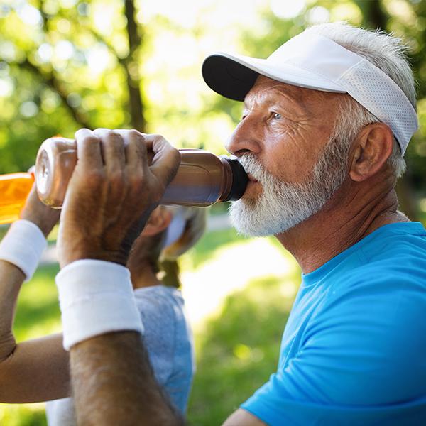 image of elderly man drinking milk protein drink