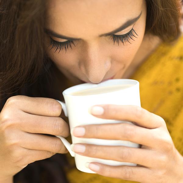 image of a woman sipping a coffee