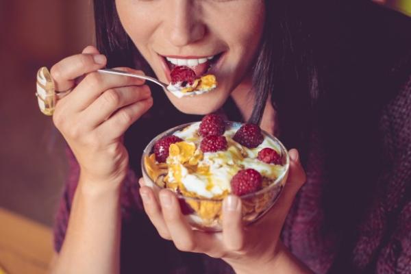 image of woman eating a yoghurt