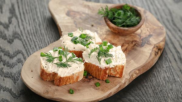 cream cheese with crackers and pesto