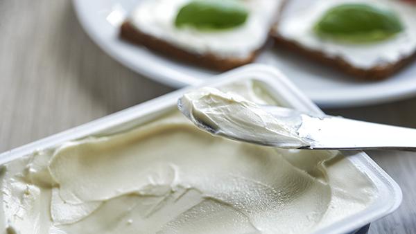 cream cheese with knife and crackers
