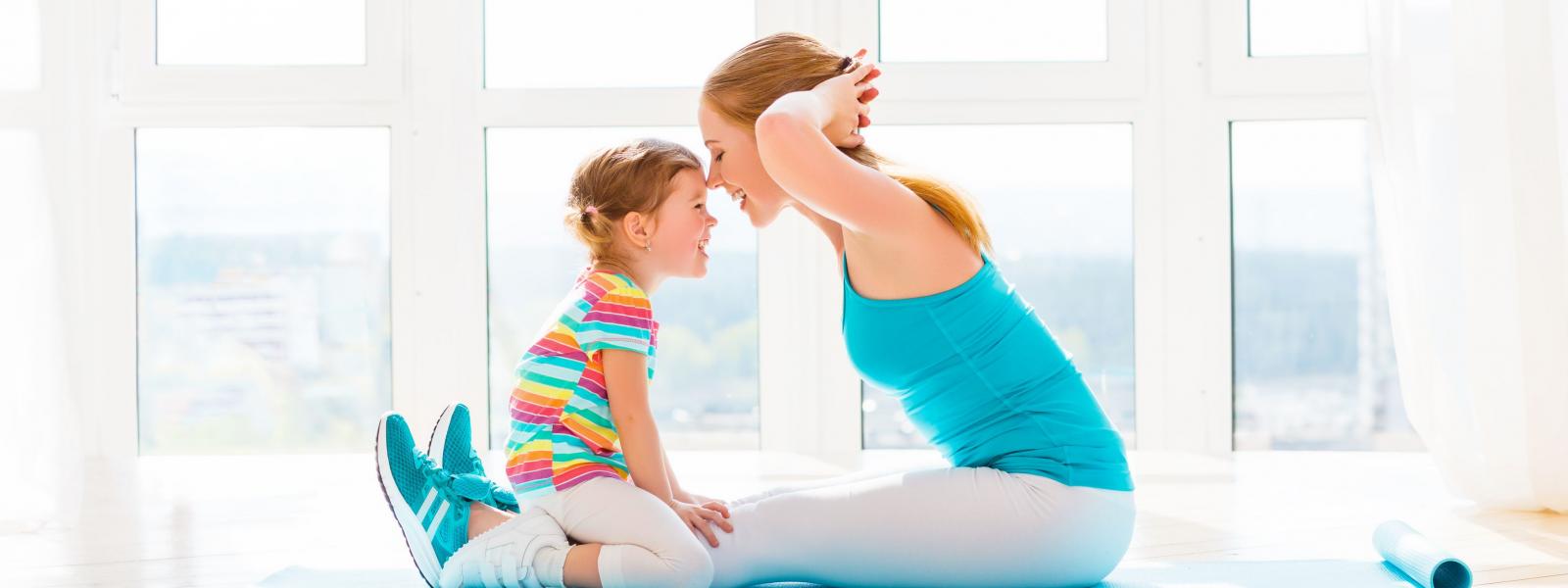 Woman doing exercise with her child watching